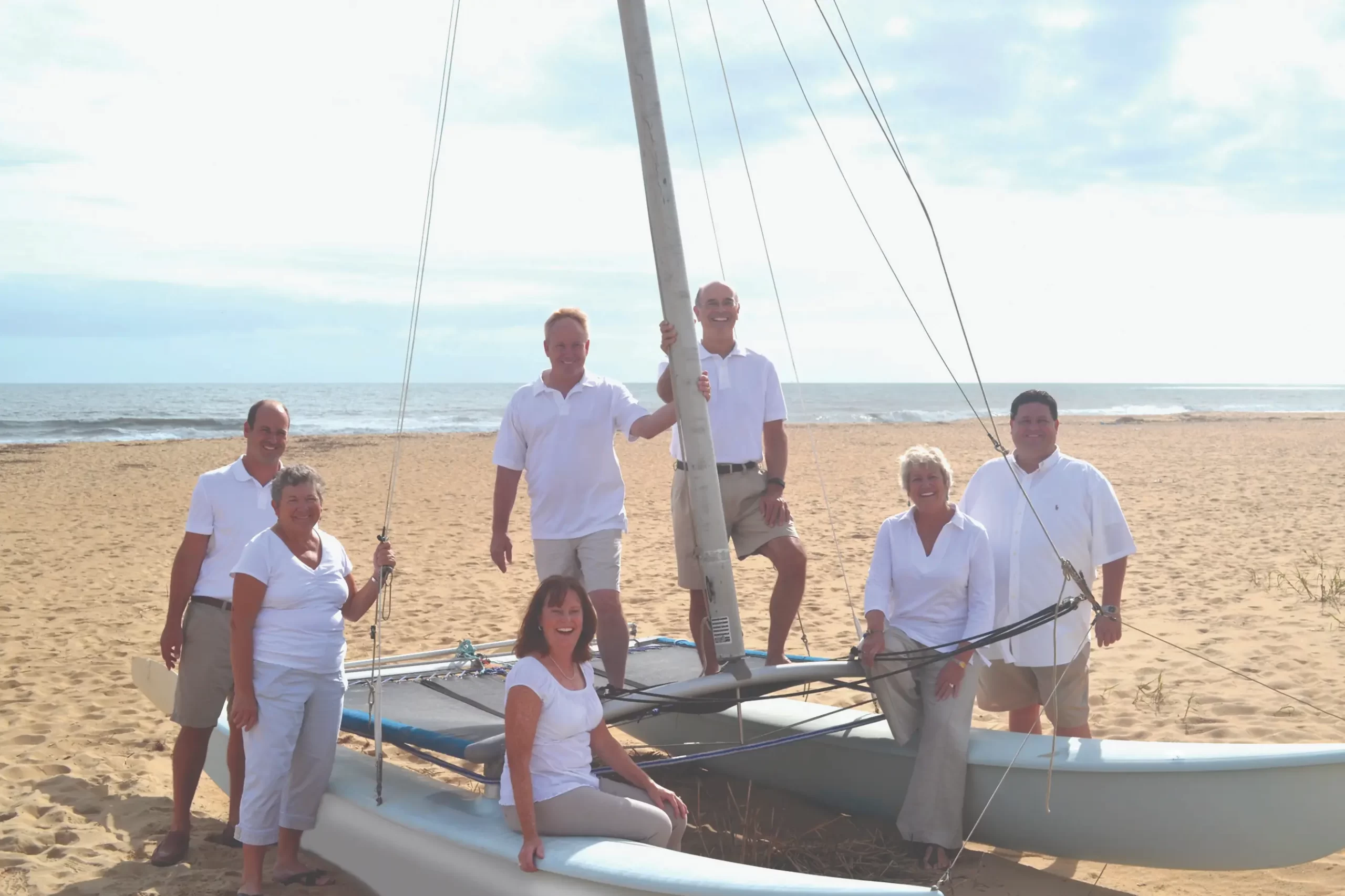 Siebert Realty Sales team standing outdoors by a boat dock, smiling and ready to assist clients