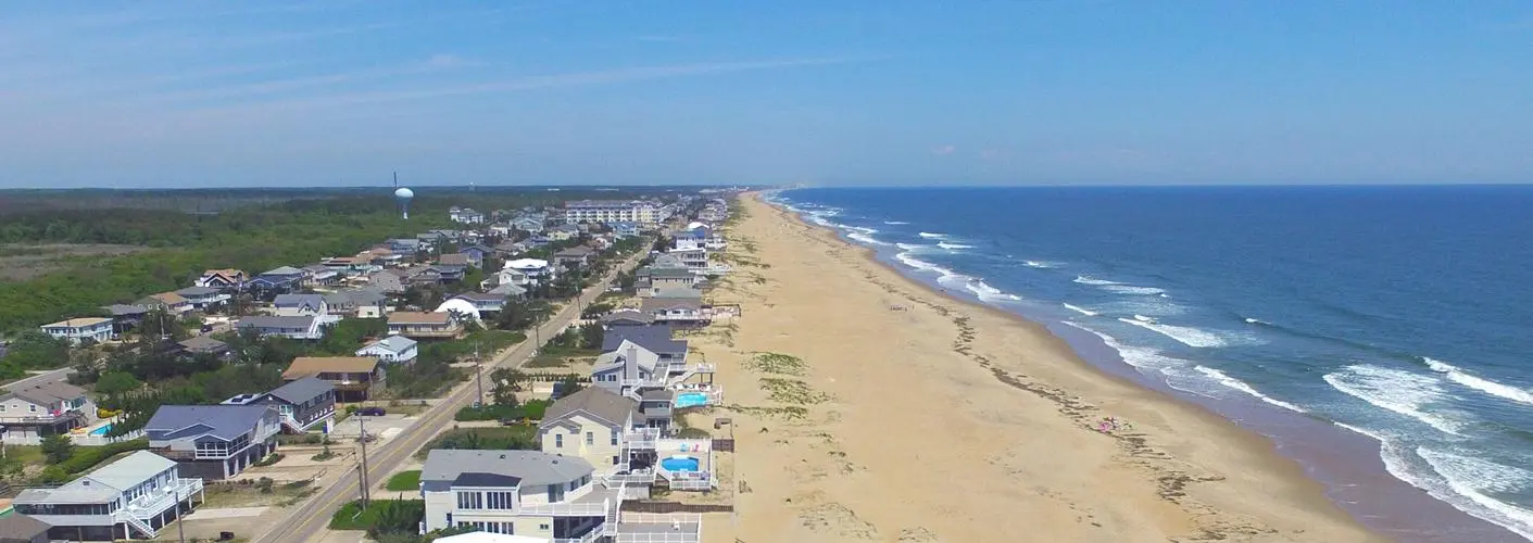 homepage-sandbridgebeach Sandbridge Beach waterfront view with residential homes and calm water – Siebert Realty Sales